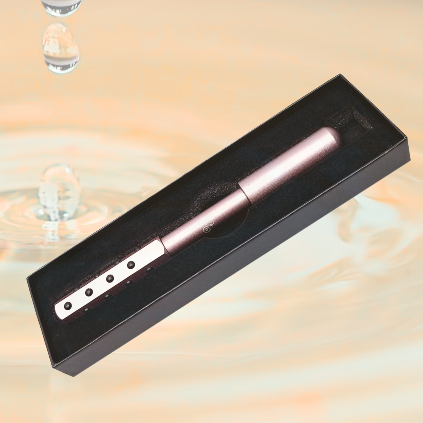 Pink germanium face roller resting inside its elegant storage box, designed for natural anti-aging facial massage and skin rejuvenation.